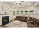 Spacious living room with a fireplace, a comfortable sectional, and plenty of natural light at 224 Osier Dr, Mcdonough, GA 30252