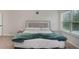 Comfortable main bedroom with a bed, two nightstands, and a large window at 224 Osier Dr, Mcdonough, GA 30252