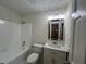 Bathroom features shower, toilet, sink, and a large mirror with modern lighting at 257 Forest Lake Rd, Lawrenceville, GA 30046