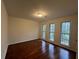 Bedroom features gleaming hardwood floors, neutral paint, and a window with views of the outdoors at 257 Forest Lake Rd, Lawrenceville, GA 30046