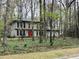 Beautiful home with a red door surrounded by trees, providing a sense of privacy and seclusion at 257 Forest Lake Rd, Lawrenceville, GA 30046