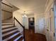 Classic foyer featuring hardwood floors, elegant staircase, and a glimpse into a cozy living space at 257 Forest Lake Rd, Lawrenceville, GA 30046