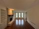 Bright living room with hardwood floors, built-in shelves and cabinets surrounding brick fireplace at 257 Forest Lake Rd, Lawrenceville, GA 30046