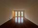 Bright living room features hardwood floors and large windows providing ample natural light at 257 Forest Lake Rd, Lawrenceville, GA 30046