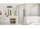 Bathroom featuring a glass-enclosed shower, a tub and vanity with a makeup table at 4236 Providence Ln, Tucker, GA 30084