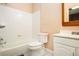 Bathroom with a tub and shower, and a vanity area with white cabinets and neutral wall color at 4236 Providence Ln, Tucker, GA 30084