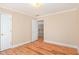 A well-lit bedroom with wood-look flooring leads to additional rooms in the house at 4236 Providence Ln, Tucker, GA 30084