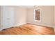 Bedroom with wood floors, double closet, window, and neutral paint at 4236 Providence Ln, Tucker, GA 30084
