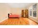 Bright bedroom boasts hardwood floors, a large window, and a decorative screen at 4236 Providence Ln, Tucker, GA 30084