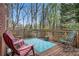 Outdoor deck with chairs and a view of the surrounding trees and foliage at 4236 Providence Ln, Tucker, GA 30084