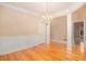 Elegant dining room with hardwood floors, wainscoting, decorative columns, and a chandelier at 4236 Providence Ln, Tucker, GA 30084