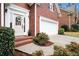 Charming entrance to brick home featuring a manicured lawn and pathway to the front door at 4236 Providence Ln, Tucker, GA 30084
