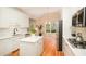 Well-lit kitchen features white cabinetry, a functional island, stainless steel appliances, and wood flooring at 4236 Providence Ln, Tucker, GA 30084