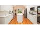 Modern kitchen boasts white cabinets, quartz countertops, stainless steel appliances, and a functional center island at 4236 Providence Ln, Tucker, GA 30084