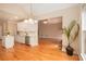Bright kitchen features white cabinets, stainless steel appliances, hardwood floors, and an adjacent living space at 4236 Providence Ln, Tucker, GA 30084