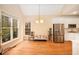 Cozy dining area next to kitchen boasts stainless steel appliances, hardwood floors, and natural light at 4236 Providence Ln, Tucker, GA 30084
