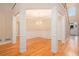 Spacious living room boasts hardwood floors, decorative columns, wainscoting and abundant natural light at 4236 Providence Ln, Tucker, GA 30084