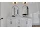 Bright bathroom features a double vanity with modern fixtures, arched mirrors, and ample storage space at 821 Camden Park Ct, Atlanta, GA 30342
