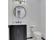 Cozy half-bathroom offering a dark vanity with modern fixtures and a bright mirror at 821 Camden Park Ct, Atlanta, GA 30342