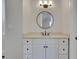 Clean bathroom with a white vanity, modern faucet, round mirror and bright light fixture at 821 Camden Park Ct, Atlanta, GA 30342