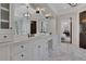 Bright bathroom with marble floors, double vanity with white cabinets, and updated fixtures at 821 Camden Park Ct, Atlanta, GA 30342