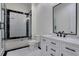 This primary bathroom features a tub/shower combo, marble countertops, and black hardware at 821 Camden Park Ct, Atlanta, GA 30342