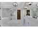 Luxurious bathroom with marble floors, double vanity, soaking tub, and a glass-enclosed shower at 821 Camden Park Ct, Atlanta, GA 30342