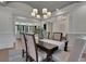 Formal dining room featuring a modern chandelier, hardwood floors, and views to the living room at 821 Camden Park Ct, Atlanta, GA 30342