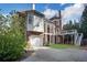 Exterior of brick home, features multiple levels, outdoor staircases, and large garage at 821 Camden Park Ct, Atlanta, GA 30342