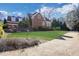Exterior view of brick home with manicured lawn, stone garden bed, and circular driveway at 821 Camden Park Ct, Atlanta, GA 30342