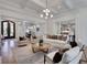 Open-concept living room with hardwood floors, abundant natural light, and neutral colors at 821 Camden Park Ct, Atlanta, GA 30342