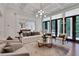 A cozy living area with a fireplace, large windows, and elegant furniture arrangement at 821 Camden Park Ct, Atlanta, GA 30342