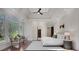 Sun-drenched main bedroom features a tray ceiling, large windows, and cozy seating area, creating a serene retreat at 821 Camden Park Ct, Atlanta, GA 30342