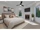 Bright main bedroom with a fireplace, modern artwork, and large windows, creating a tranquil space at 821 Camden Park Ct, Atlanta, GA 30342