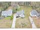 Aerial view of the property showcasing the home, driveway, and expansive yard at 1991 Mcafee Pl, Decatur, GA 30032