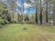 Spacious backyard featuring mature trees and an inviting fire pit area at 1991 Mcafee Pl, Decatur, GA 30032