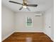 An empty bedroom features a modern ceiling fan and newly refinished hardwood floors at 1991 Mcafee Pl, Decatur, GA 30032