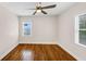 Bright bedroom with hardwood floors and natural light from two windows at 1991 Mcafee Pl, Decatur, GA 30032