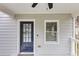 Charming covered front porch featuring a fan, a black front door, and a railing at 1991 Mcafee Pl, Decatur, GA 30032