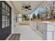 Inviting front porch with an overhead ceiling fan and view of the front yard at 1991 Mcafee Pl, Decatur, GA 30032