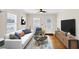 Bright living room with white sofa, wood floors, stylish rug, and modern décor at 1991 Mcafee Pl, Decatur, GA 30032