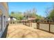 A wooden deck with black railings overlooks the lawn and fenced-in yard at 2041 Briarcliff Ne Rd, Atlanta, GA 30329