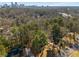 Aerial view shows the house surrounded by trees with the skyline in the background at 725 Glengary Ne Way, Atlanta, GA 30342