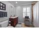 Bright bathroom featuring white trim, a wooden vanity, a plush rug, and a shower/tub combo with neutral tile at 725 Glengary Ne Way, Atlanta, GA 30342