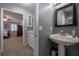 Bathroom with a stylish vanity, pedestal sink, and neutral color palette at 725 Glengary Ne Way, Atlanta, GA 30342
