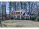 Beautiful two-story home with a brick facade, black shutters, and a spacious front lawn at 725 Glengary Ne Way, Atlanta, GA 30342