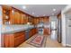 Classic kitchen with wood cabinetry, stainless appliances, and hardwood flooring at 725 Glengary Ne Way, Atlanta, GA 30342
