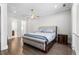 Bedroom featuring a bed with a tufted headboard, ceiling fan, and doorways to the bathroom and closet at 3371 Dogwood Dr # 220, Hapeville, GA 30354