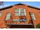 Brick building exterior with 'Hapeville Mill' sign, vintage windows and covered entryway creates historic charm at 3371 Dogwood Dr # 220, Hapeville, GA 30354