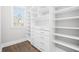 Organized walk-in closet with custom shelving, drawers, hardwood floors, and a window for natural light at 3371 Dogwood Dr # 220, Hapeville, GA 30354
